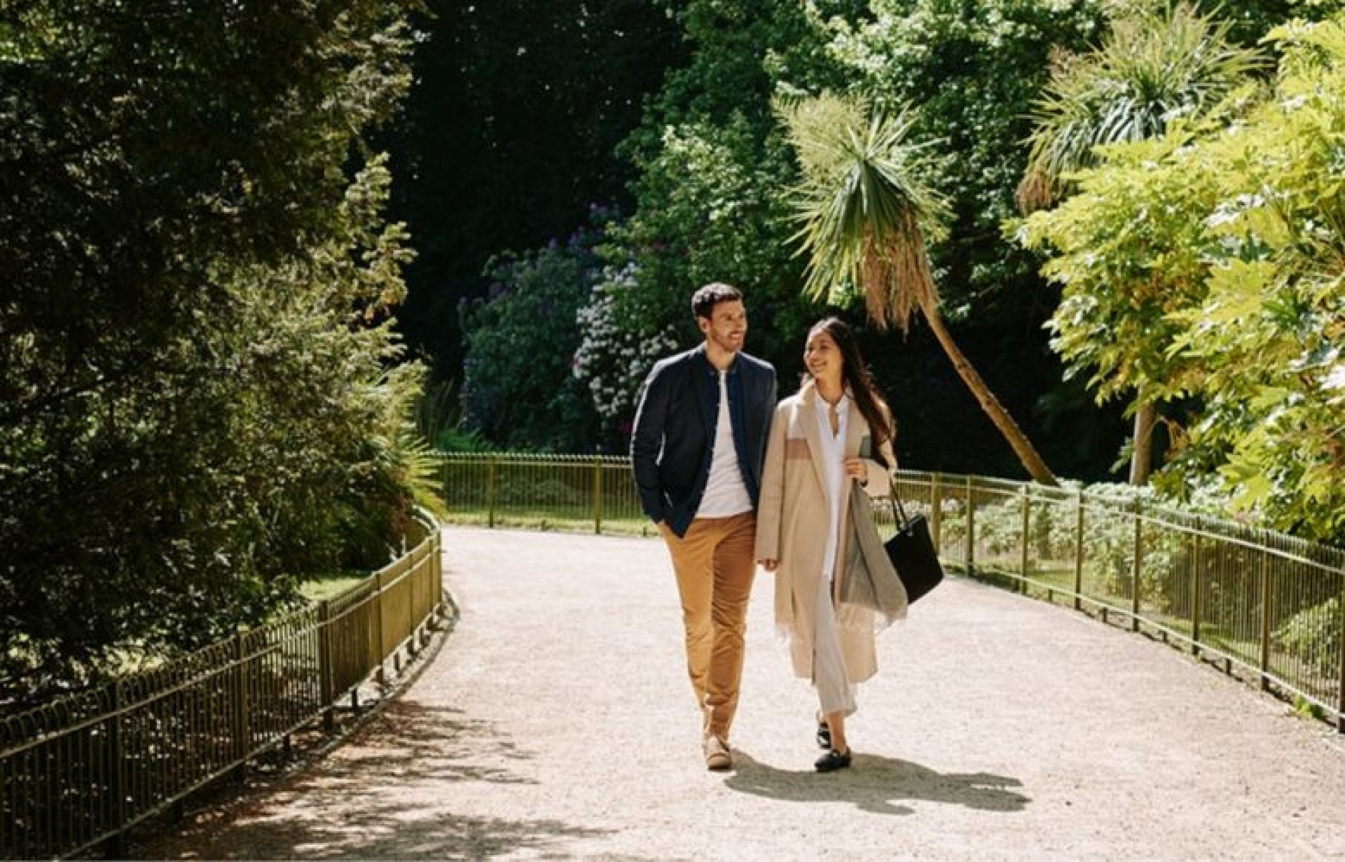 a young couple walking in the battersea park